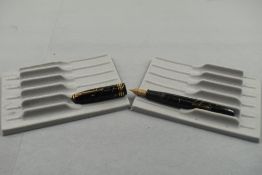 A Conway Stewart 58 leverfill fountain pen in black with gold veining with one broad band and two