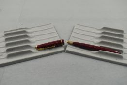 A Parker Slimfold fountain pen in burgundy with narrow decorative band to the cap and having a