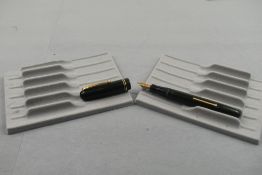 A Mabie Todd Swan 3240 leverfill fountain pen in green with two narrow bands to the cap having