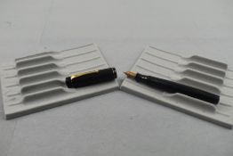 A Mentmore Auto Flow buttonfill fountain pen in black with chaised pattern having a single narrow