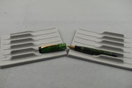 A Parker Duofold fountain pen in green with two narrow bands to the cap and having a Parker
