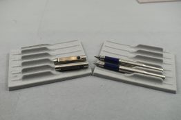 Two Parker 25 Flighter fountain pens in stainless steel