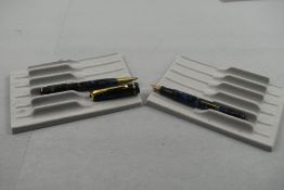 A Burnham leverfill fountain pen and propelling pencil in blue and black marble with gold veining