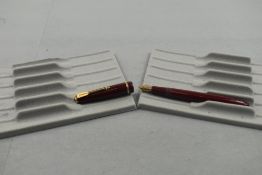A Parker Slimfold fountain pen in burgundy with single decorative band to cap with Parker 5 nib.