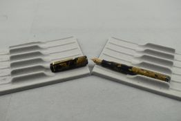 A Mentmore Diploma leverfill fountain pen in black and gold with single narrow band to the cap