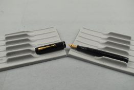 A Mentmore Auto Flow button fill fountain pen in black with single broad band to the cap having