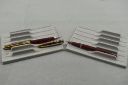 A Conway Stewart 69 fountain pen and propelling pencil in red with worn steel cap having Conway