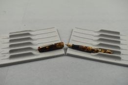 A Wahl Oxford leverfill fountain pen in gold, red and brown with two narrow bands to the cap