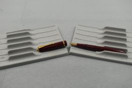 A Parker Slimfold fountain pen in burgundy with single decorative band to cap with Parker 5 nib.