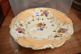 A 19th century porcelain comport, decorated with foliate sprays and scrolling gilt borders, with