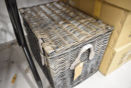A wicker woven picnic hamper