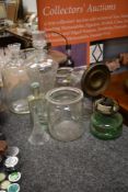 A selection of glass wares including oil dispenser, decanter and storage jars