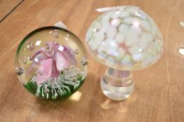 Two paper weights one being a lamp worked flower and a similar lustre glaze glass mushroom