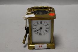 A 20th century brass cased five-glass carriage timepiece, of traditional design with swing handle