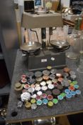 Two sets of bank money weighing scales with a large amount of weights including bronze measures