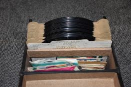 A vintage record case with 7inch singles and loose shellac LP's