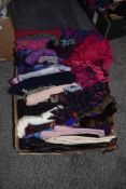 A box full of mixed scarves and gloves.