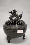 A late 19th century Chinese cast-bronze temple censer, of circular form with dog of foe form