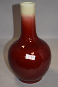 A Chinese porcelain bottle vase having graded flambe glaze with cream underglaze