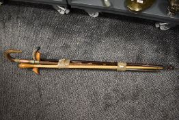 A selection of walking sticks and canes including beech wood, mahogany and horn handle