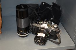 A photographers camera Canon AE-1 with macro lens and a Tamron 1;3.8 80-120mm lens