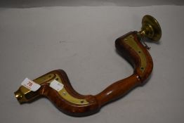 A Victorian cabinet makers bit and brace having brass supports with oak frame
