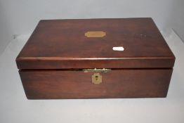 An Edwardian mahogany writing slope with two glass ink wells