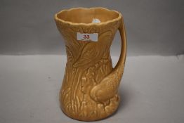 A 1950's Sylvac Pottery 'Budgerigar' pattern jug, in beige, moulded number 1370 to base, 19cm.