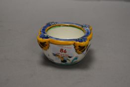 A small hand decorated delft bowl in a French or Dutch style