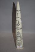 A modern scrimshaw replica marine tusk