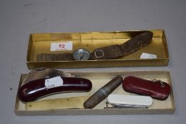 Four pocket or pen knives and a wrist mounted compass