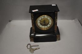 A Victorian mantle or bracket clock having slate and marble case with enamel face