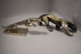 A metal cast Jaguar car style mascot and a similar ceramic figure of a puma