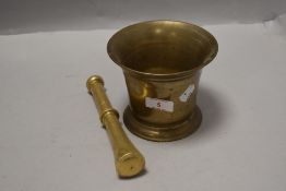 A Victorian brass cast apothecary mortar and pestle in a plain design