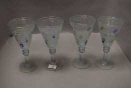 A group of four conical wine glasses, the soda glass style conical bowls decorated with floral canes