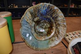 A modern studio pottery ceramic charger plate having a nature inspired glaze by John Calver