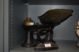 A cast kitchen balance scale set with weights