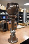 An arts and crafts style Bretby jardiniere and stand 87cm tall approx having copper effect finish