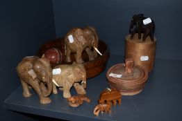 A selection of treen wood items including African elephants and fruit bowl