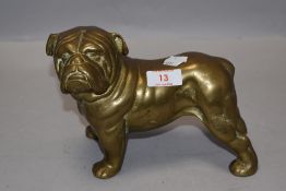 A solid cast-brass bulldog figure, of iconic stance and design.