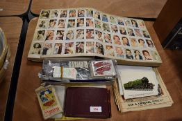 A selection of collectable cigarette and tea cards along with similar ephemera