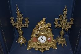 A good quality reproduction brass and marble French style figural mantel clock, and garnitures. Of