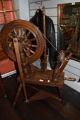 A 20th century traditional wool spinning wheel having turned oak frame