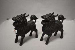 A matching pair of bronze cast temple dogs or Fu dogs both in standing positions