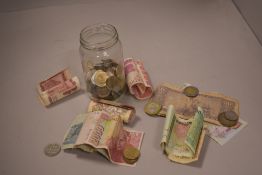 A selection of collectable coins and currency including coins and paper notes