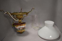 A brass and ceramic ceiling light pendant in the form of an oil lamp having hunting theme design