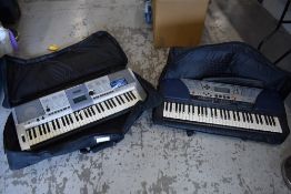 Two modern Yamaha keyboards , in gig bags , and an M Audio sustain pedal