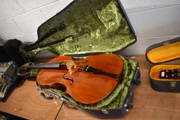 A traditional cello, in hard shell paxman case with bow, two piece back approx. 30 inch