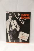 A card shop promo for David Bowie's ' Absolute Beginners ' - viewing recommedned