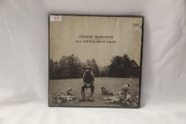A copy of ' All Things Must Pass ' by George Harrison , some box damage as shown but a decent